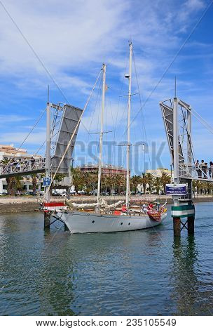 Lagos, Portugal - June 9, 2017 - Yacht Passing Through The Open Bascule Footbridge Along The River B