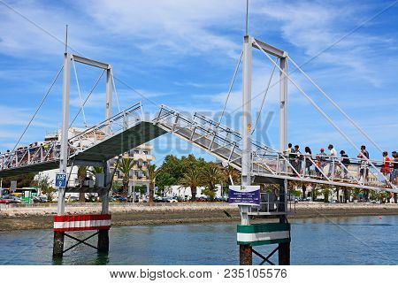Lagos, Portugal - June 9, 2017 - Pedestrians Waiting For The Footbridge Along The River Bensafrim To