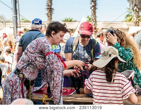Goren, Israel, April 06, 2018 : A Participant In The Knight Festival Shows Visitors How To Weave Wit