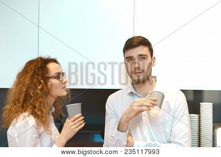 Picture Of Two Stylish Creative Coworkers Male And Female In Formal Wear Holding Disposable Papercup