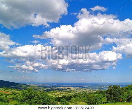Green farmland and sky for background