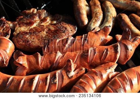 German Bratwurst And Other Sausages On Barbecue Grill