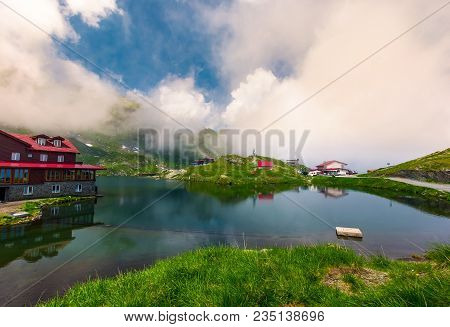 Area Of Lake Balea In Clouds. Gorgeous Summer Landscape Of Fagarasan Mountains, Romania. Popular Tou