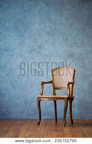 Old Chair On A Gray Wall Background