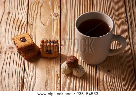 Cup Of Tea With Tasty Cookies On Wooden Background