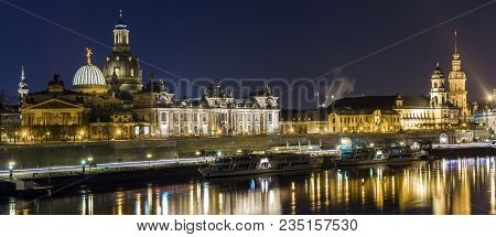Night Cityscape View Of Historic Buildings With Reflections In Elbe River In The Center Of Dresden (