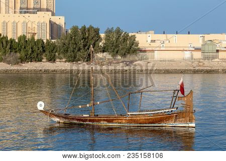DOHA, QATAR - April 7, 2018: A small traditioonal Arab boat moored in the museum lagoon in Doha, Qatar.