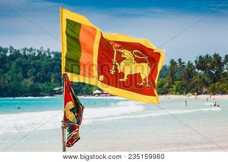 Flag of Sri Lanka on the wonderful beach in Mirissa. Sri Lanka.