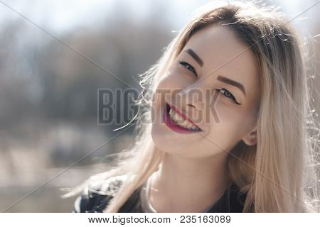 Outdoors Portrait Of Beautiful Young Brunette Girl. Woman Smiling Happy On Sunny Summer Or Spring Da