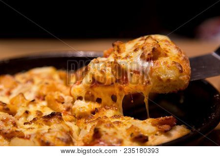Hot Pizza Slice With Melting Cheese On A  Table In Restaurant Pizza Italian Food.
