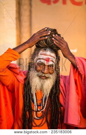 VARANASI, INDIA - MAR 19, 2018: Sadhu or Baba (holy man) on the ghats of Ganges river. Normally a sadhu is a monk, renounced, renounced material enjoyment. In India from 4 to 5 million sadhu.