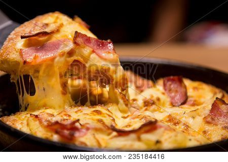 Hot Pizza Slice With Melting Cheese On A  Table In Restaurant Pizza Italian Food.