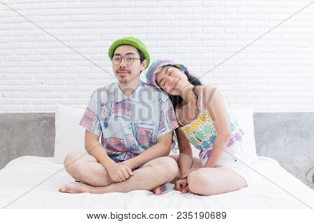 Couple Asian Man And Woman With Woolhat Together Funny Moment On White Bed