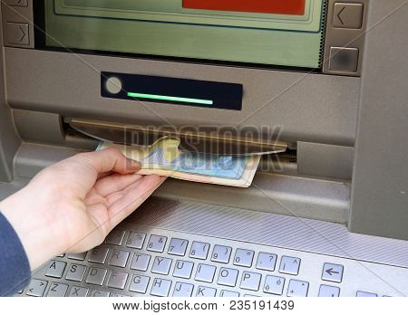 Young Boy Withdraws Money From An Atm With Euro Currency