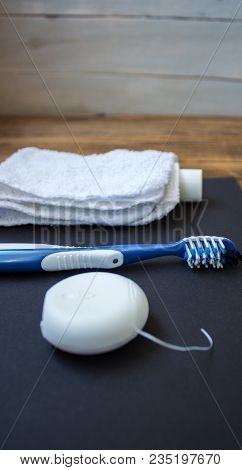 Dental Floss Toothbrush Toothpaste Towel On Wooden Background