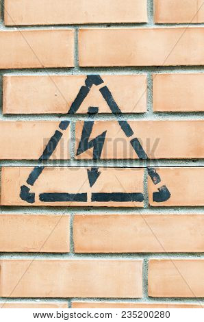 High Voltage Danger Yellow Sign On A Brick Wall Building