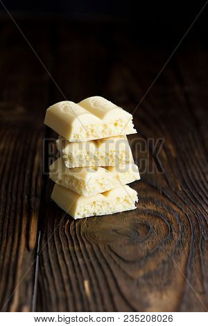 Pyramid Of White Porous Chocolate On A Wooden Vintage Old Background In The Style Of Moodle