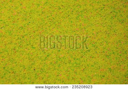 Texture Of A Colored Granular Sand Close Up. Yellow Grains