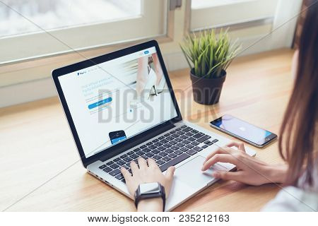 Bangkok, Thailand - April 09, 2018 : Woman Use Laptop On The Table Showing Screen Paypal Web Pages. 