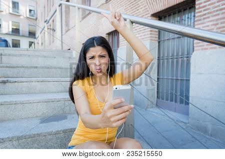 Attractive Latin Woman Listening To Music On Her Smart Phone