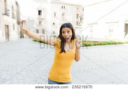 Attractive Brunet Latin Woman Smiling And Being Happy While Taking A Selfie On Holidays In Spain In 
