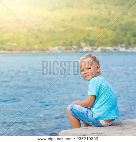Cute caucasian boy at seaside. Leisure time