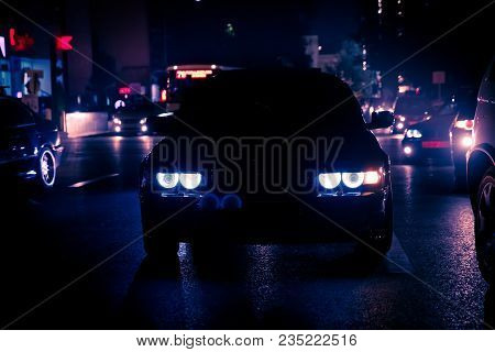 Road In The City At The Night With Yellow And Red Electrical Light For Cars During They Are Coming H