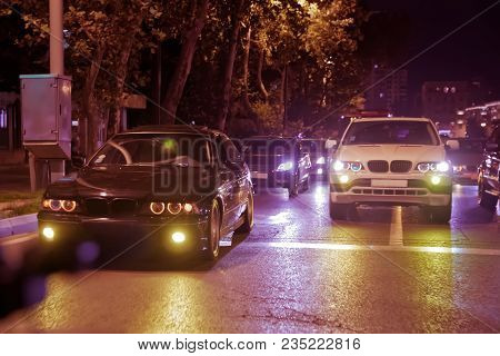 Road In The City At The Night With Yellow And Red Electrical Light For Cars During They Are Coming H