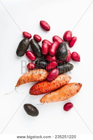 Different Varieties In Form And Color Of Potatoes  On A White Isolated Background. Red, Shetland Bla