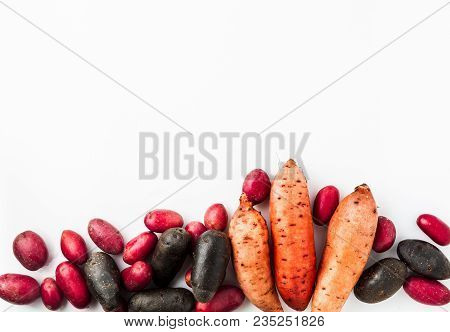 Different Varieties In Form And Color Of Potatoes  On A White Isolated Background. Red, Shetland Bla