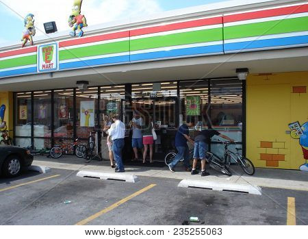 People Entering A Seven Eleven Turned Into A Kwik E Mart To Promote The Simpsons Movie, Chicago, Il 
