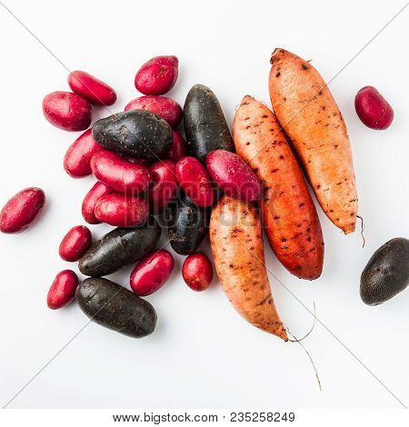 Different Varieties In Form And Color Of Potatoes  On A White Isolated Background. Red, Shetland Bla