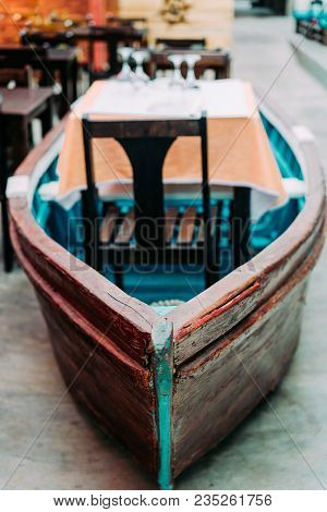 Unusual Restaurant Interior: Dining Table In The Colorful Fish Boat. Marine Ambience.