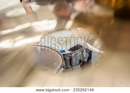 Drummer Playing On Drum Set Top View. Live Music Concert, Band During Performance. View And Look Thr