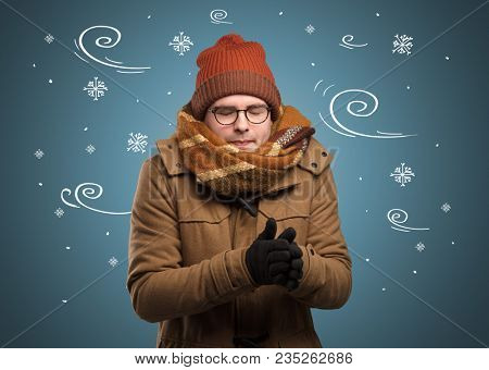 Young hipster frozen boy with doodled snowflakes and windy concept