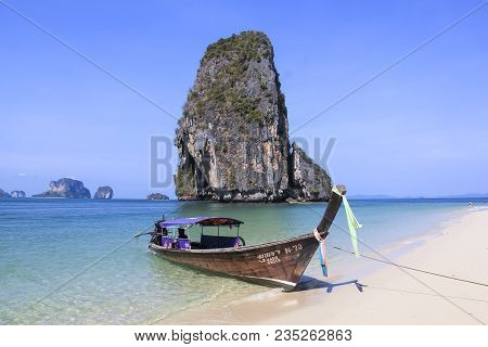 Railay Beach, Krabi, Thailand - April 8 2015 Traditional Wooden Longtail Boat Anchored On Railay Bea