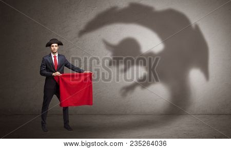Businessman standing with red cloth in his hand and imp shadow on the background