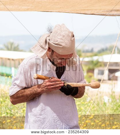 Goren, Israel, April 06, 2018 : Wood Carver - Participant In The Knight Festival Cut Out A Spoon In 
