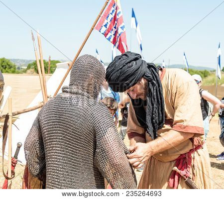 Goren, Israel, April 06, 2018 : A Participant In The Knight Festival Helps The Visitor To Dress The 