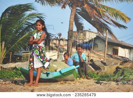Negombo, Sri Lanka, February 2013: Children Standing On The Beach Around The Boat.