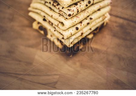 Pancakes Arranged In The Pile On The Wooden Board