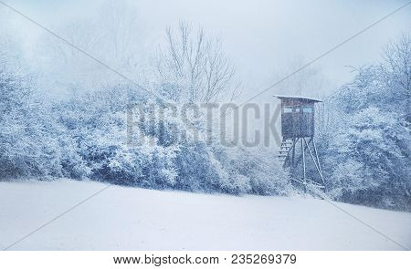 Hunting Hide. Winter In Central Europe. Snowfall. White And Blue Shadows.