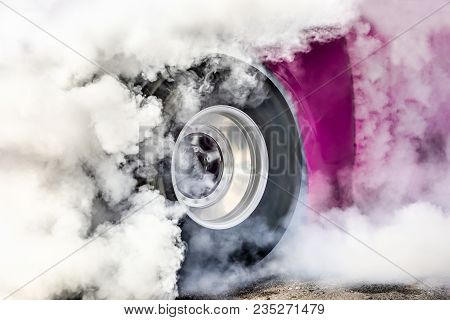 Drag Racing Car Burns Rubber Off Its Tires In Preparation For The Race