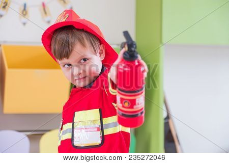 Caucasian Boy Kid Dress Up To Fireman And Use Speaker At Roll Play Classroom,kindergarten Preschool 