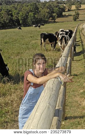 Portrait Of A Farmer With Her Cows In The Field