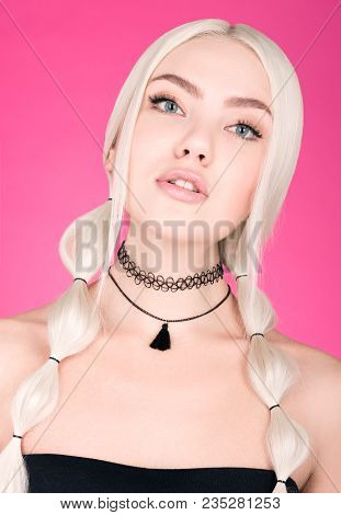 Portrait Of Beautiful Young Woman With Stylish Hairstyle On A Bright Pink Background. Chocker And Bl