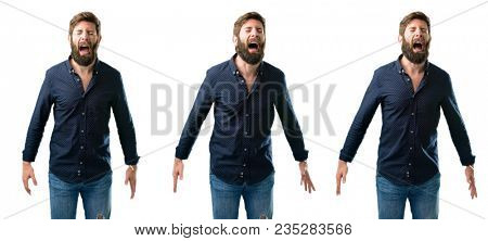Young man with beard stressful, terrified in panic, shouting exasperated and frustrated. Unpleasant gesture. Annoying work drives me crazy isolated over white background