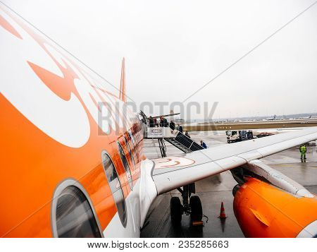 Hamburg, Germany - Mar 22, 2018: People Entering Easyjet Airplane Early In The Morning In Flughafen 