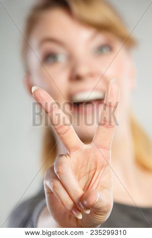 Celebration Communication Success Concept. Cheerful Lady Makes V Gesture. Young Girl Showing Peace S