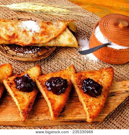 Delicious Fried Homemade Toast With Jam On A Wooden Cutting Board. And As Pancake With Jam And Sugar